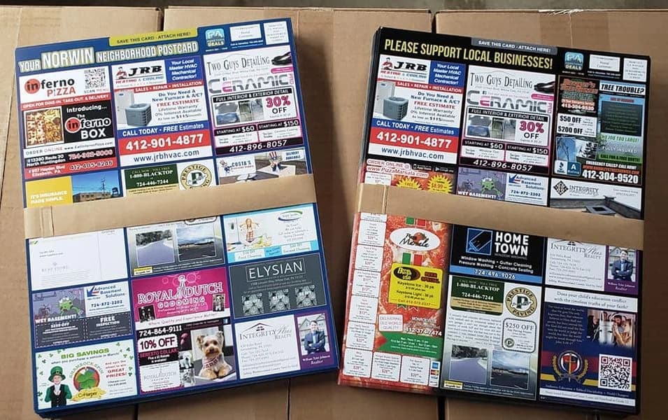 Two finished Big Local Card style mailers laid out for review.